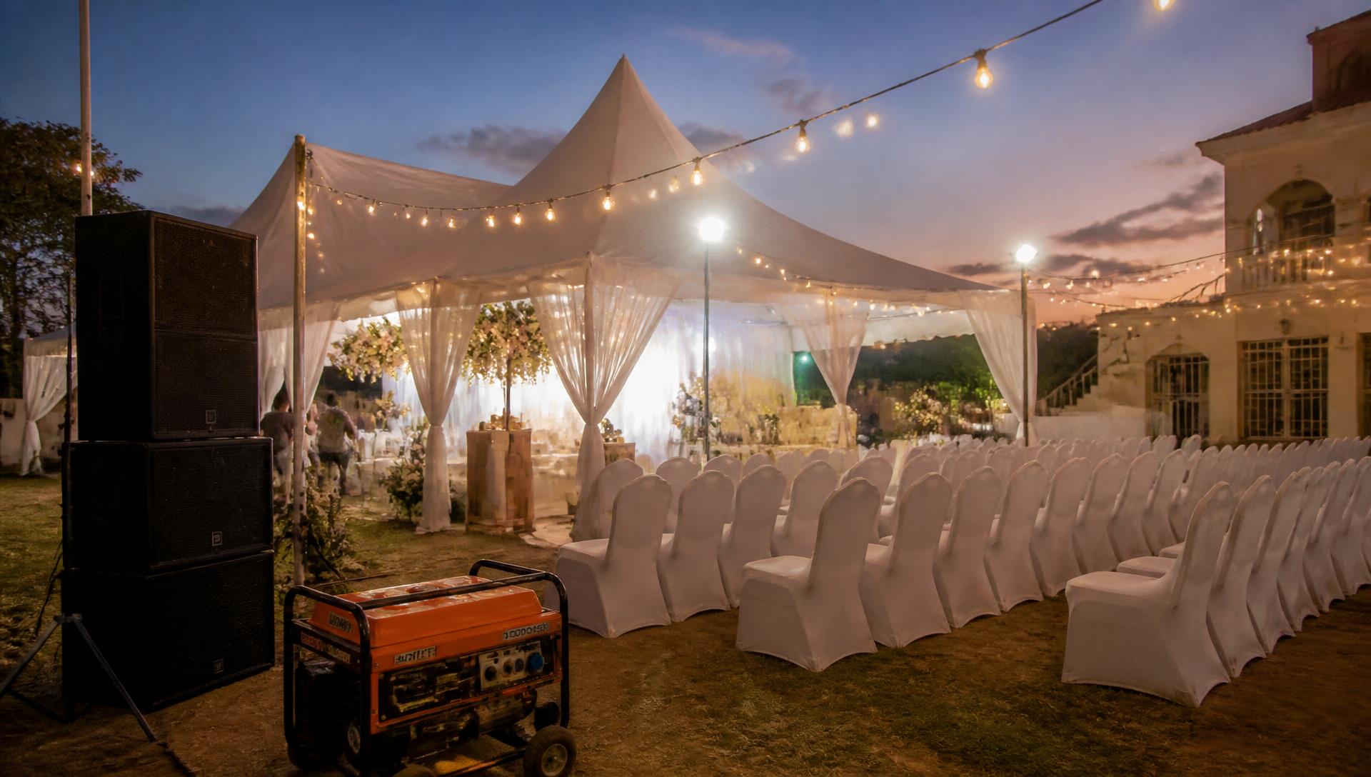 Outdoor wedding marquee with lighting and a generator